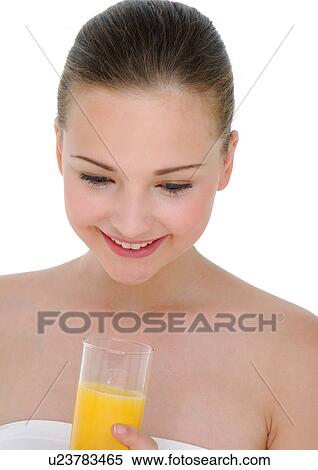 Close-up of a young woman holding a glass of orange juice and grining View Large Photo Image Stock Photography - Close-up of a young woman holding a glass of orange juice and grining. Fotosearch