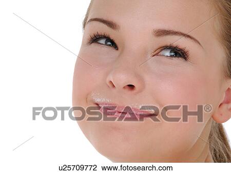 Stock Image - Close-up of a young woman with milk moustache. Fotosearch