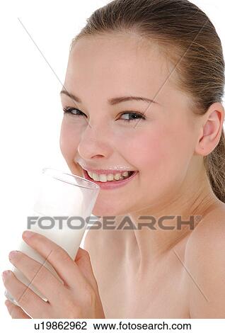 Portrait of a young woman drinking a glass of milk and grining View Large Photo Image Stock Image - Portrait of a young woman drinking a glass of milk and grining. Fotosearch