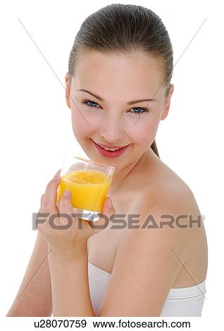 Portrait of a young woman holding a glass of orange juice and grining View Large Photo Image Stock Photo - Portrait of a young woman holding a glass of orange juice and grining. Fotosearch