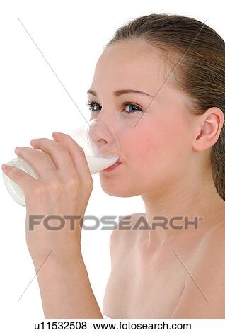 Stock Photo - Side profile of a young woman drinking a glass of milk. Fotosearch