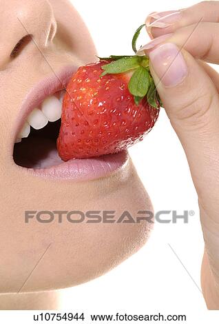 Close-up of a young woman eating a strawberry View Large Photo Image Picture - Close-up of a young woman eating a strawberry. Fotosearch