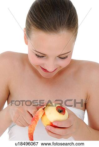 Stock Photo - Close-up of a young woman peeling an apple. Fotosearch