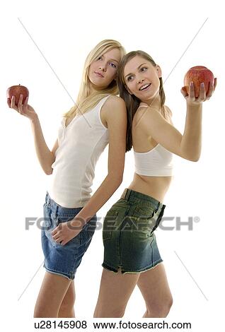Close-up of two young women holding apples View Large Photo Image Stock Photo - Close-up of two young women holding apples. Fotosearch