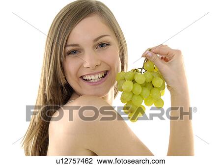 Portrait of a young woman holding a bunch of grapes and grining View Large Photo Image Stock Image - Portrait of a young woman holding a bunch of grapes and grining. Fotosearch