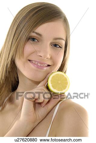 Portrait of a young woman holding a cross section of a lime and smiling View Large Photo Image Stock Image - Portrait of a young woman holding a cross section of a lime and smiling. Fotosearch