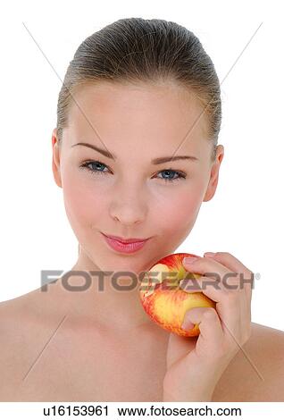 Portrait of a young woman holding an apple View Large Photo Image Stock Image - Portrait of a young woman holding an apple. Fotosearch