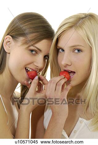 Portrait of two young women eating strawberries View Large Photo Image Stock Photography - Portrait of two young women eating strawberries. Fotosearch