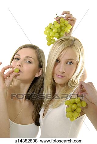 Portrait of two young women holding bunches of grapes View Large Photo Image Stock Photo - Portrait of two young women holding bunches of grapes. Fotosearch