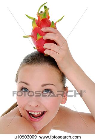 Close-up of a young woman holding a pitaya fruit on her head View Large Photo Image Stock Photo - Close-up of a young woman holding a pitaya fruit on her head. Fotosearch