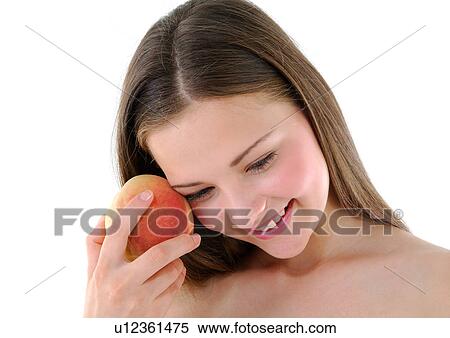 Close-up of a young woman holding a peach and smiling View Large Photo Image Stock Photography - Close-up of a young woman holding a peach and smiling. Fotosearch