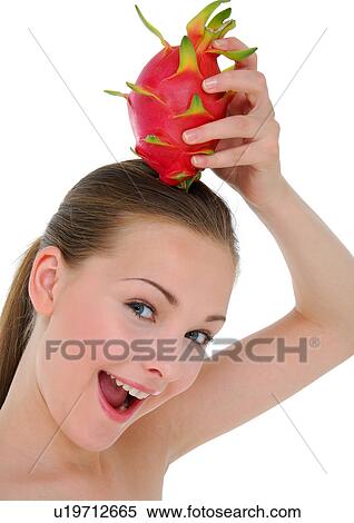 Close-up of a young woman holding a pitaya fruit on her head View Large Photo Image Stock Photography - Close-up of a young woman holding a pitaya fruit on her head. Fotosearch