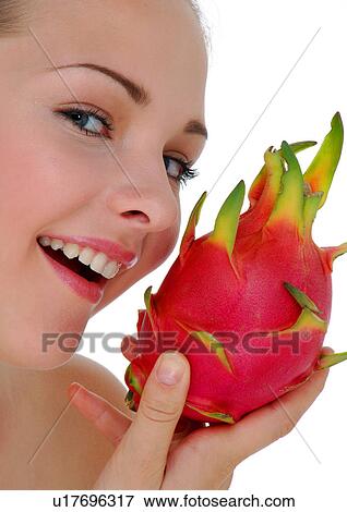 Portrait of a young woman holding a pitaya fruit and smiling View Large Photo Image Stock Photo - Portrait of a young woman holding a pitaya fruit and smiling. Fotosearch