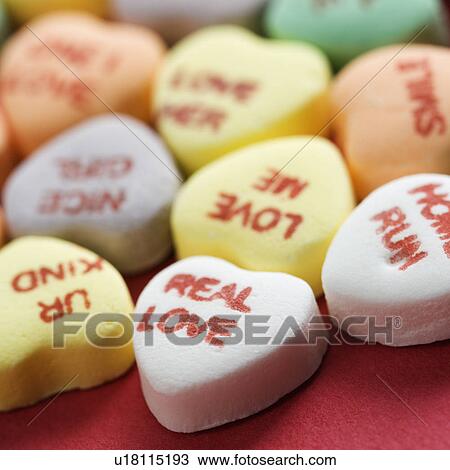 Colorful candy hearts with sayings on them arranged on red background. View Large Photo Image Stock Image - Colorful candy hearts with sayings on them arranged on red background.. Fotosearch