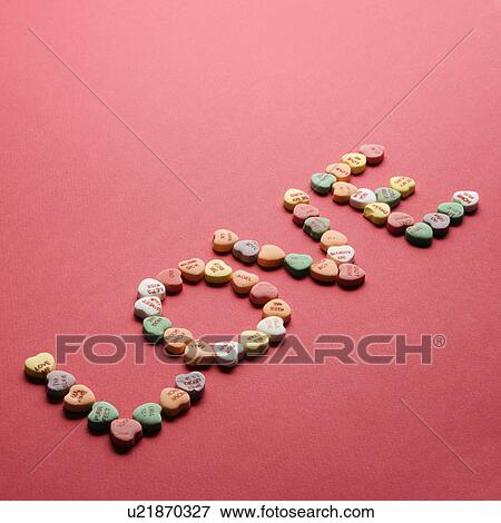 Colorful candy hearts with sayings on them arranged to spell the word love. View Large Photo Image Stock Photo - Colorful candy hearts with sayings on them arranged to spell the word love.. Fotosearch