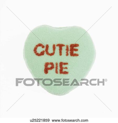 Stock Photo - Green candy heart that reads cutie pie against white background.. Fotosearch