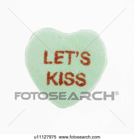 Stock Photography - Green candy heart that reads lets kiss against white background.. Fotosearch