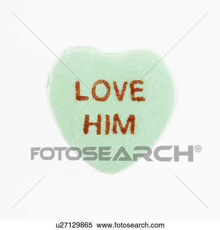 Stock Photography - Green candy heart that reads love him against white background.. Fotosearch