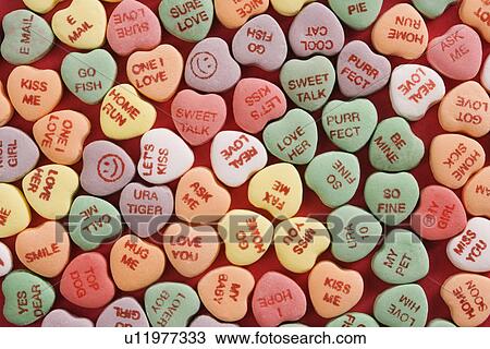 Large group of colorful candy hearts with sayings on them arranged on red background. View Large Photo Image Stock Image - Large group of colorful candy hearts with sayings on them arranged on red background.. Fotosearch