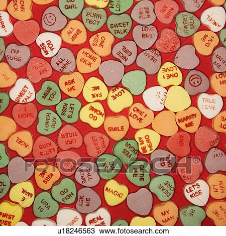 Large group of colorful candy hearts with sayings on them arranged on red background. View Large Photo Image Stock Image - Large group of colorful candy hearts with sayings on them arranged on red background.. Fotosearch