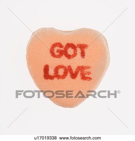 Orange candy heart that reads got love against white background. View Large Photo Image Stock Photo - Orange candy heart that reads got love against white background.. Fotosearch