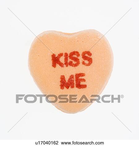 Orange candy heart that reads kiss me against white background. View Large Photo Image Stock Image - Orange candy heart that reads kiss me against white background.. Fotosearch