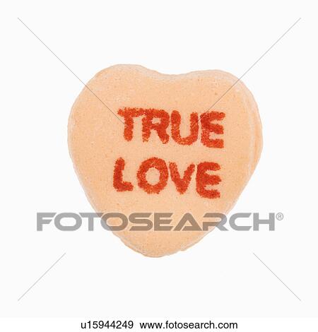 Orange candy heart that reads true love against white background. View Large Photo Image Stock Photo - Orange candy heart that reads true love against white background.. Fotosearch