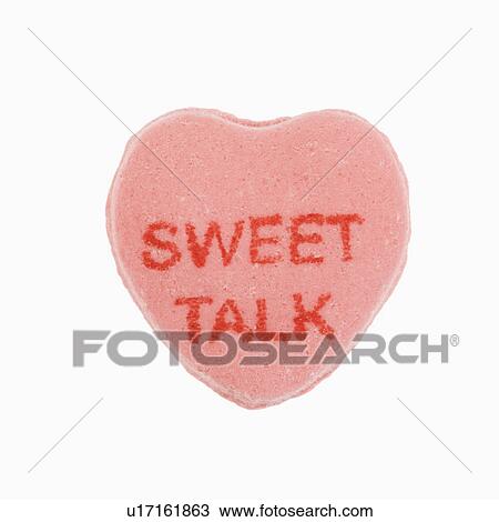 Stock Image - Pink candy heart that reads sweet talk against white background.. Fotosearch