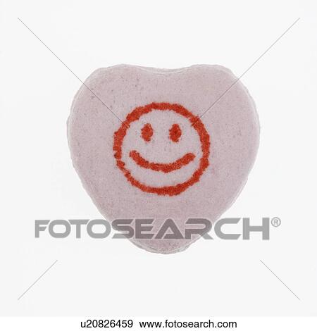 Stock Photo - Purple candy heart with smiley face against white background.. Fotosearch