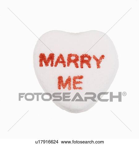 White candy heart that reads marry me against white background. View Large Photo Image Picture - White candy heart that reads marry me against white background.. Fotosearch