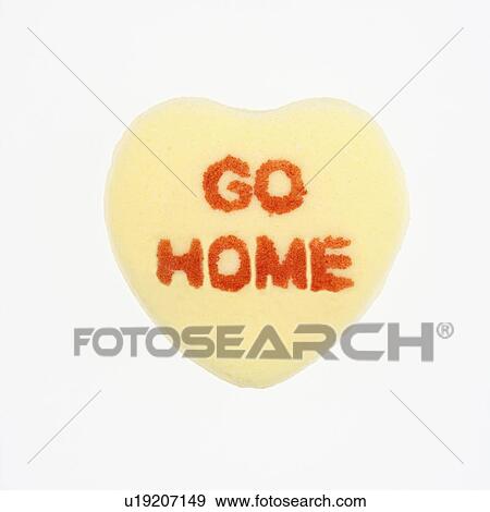Yellow candy heart that reads go home against white background. View Large Photo Image Stock Photo - Yellow candy heart that reads go home against white background.. Fotosearch