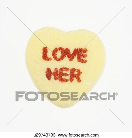 Stock Image - Yellow candy heart that reads love her against white background.. Fotosearch