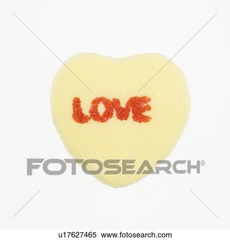 Yellow candy heart that reads love against white background. View Large Photo Image Stock Photography - Yellow candy heart that reads love against white background.. Fotosearch