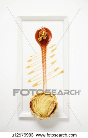 Stock Image - Apple stilton tart with glazed walnuts and caramel.. Fotosearch
