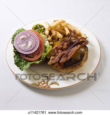 Stock Image - Cheeseburger with bacon and french fries on a plate.. Fotosearch
