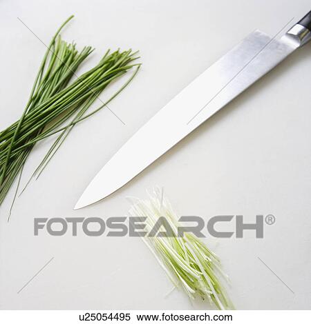Stock Photography - Fresh chives with kitchen knife resting on countertop.. Fotosearch
