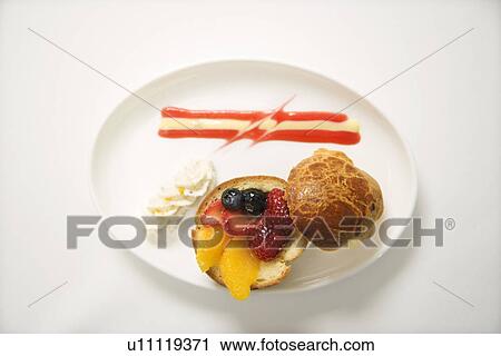 Stock Image - Fresh fruit stuffed brioche with vanilla anglaise.. Fotosearch