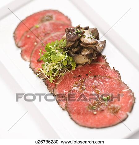 Stock Image - Pepper charred beef carpaccio with mushrooms.. Fotosearch
