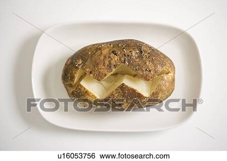 Plain baked potato sliced down the middle on a plate. View Large Photo Image Stock Photograph - Plain baked potato sliced down the middle on a plate.. Fotosearch