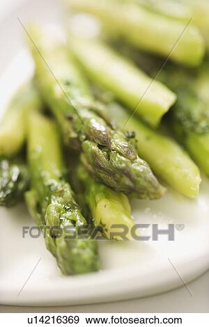 Stock Photo - Plate of green cooked asparagus.. Fotosearch