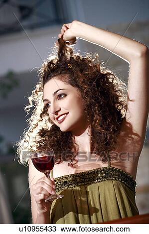 A woman in a bar drinking wine View Large Photo Image Stock Image - A woman in a bar drinking wine. Fotosearch