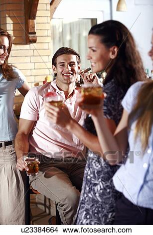 Picture - Man in bar with women. Fotosearch