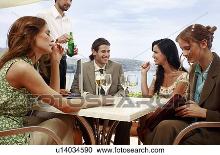Office workers having drinks in outdoor cafe View Large Photo Image Stock Image - Office workers having drinks in outdoor cafe. Fotosearch