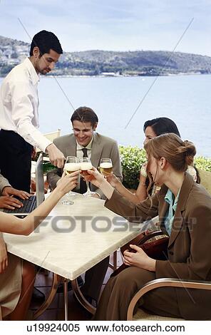 Stock Photography - Office workers having drinks in outdoor cafe. Fotosearch