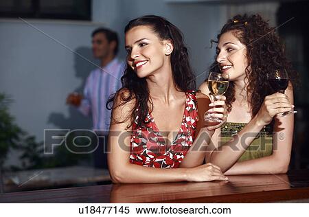 Stock Photography - Two women in a bar. Fotosearch