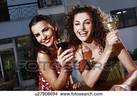 Picture - Two women in a bar with wine. Fotosearch