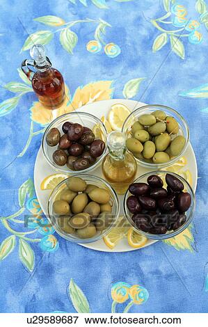 Stock Photo - Assortment of olives with oil and vinegar. Fotosearch