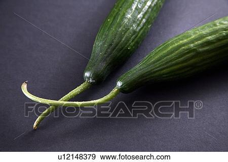 Stock Photo - Cucumbers, black background. Fotosearch