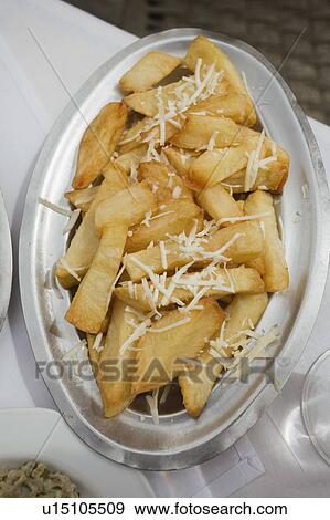 Stock Photo - French fries with grated cheese. Fotosearch