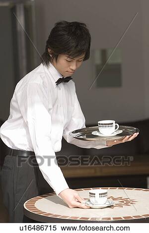 Stock Photography - A Waiter Serving Drinks, Side View, Differential Focus. Fotosearch